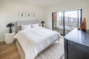 Durham apartment for rent - a bedroom with a large bed and a sliding glass door to a balcony