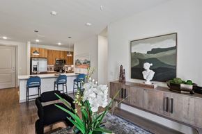 Georgetown apartment for rent - A kitchen with a bar and a painting on the wall.