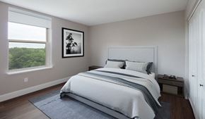 Minneapolis apartment for rent - A bedroom with a large bed and a picture on the wall.