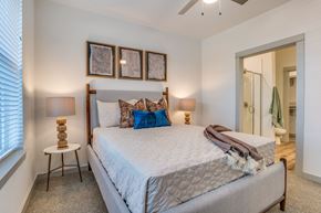 Melissa apartment for rent - A bedroom with a large bed and a ceiling fan.