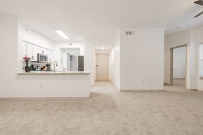 Garland apartment for rent - an empty living room with a kitchen and a door to a hallway