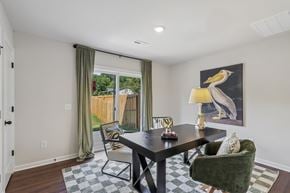 Charlotte townhouse for rent - A dining room with a black table and green chairs.