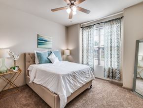Wylie apartment for rent - A bedroom with a large bed and a ceiling fan.
