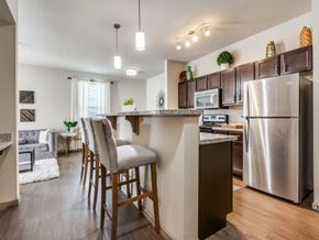 Wylie apartment for rent - A kitchen with a bar stool in front of the counter.