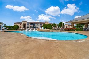 Denison apartment for rent - a swimming pool with a building in the background