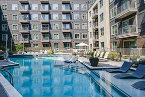 Dallas apartment for rent - A large swimming pool in front of apartment buildings.