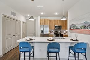 Georgetown apartment for rent - A kitchen with a white counter and blue chairs.