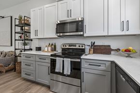 Elkhorn townhouse for rent - A modern kitchen with a stainless steel oven and white cabinets.