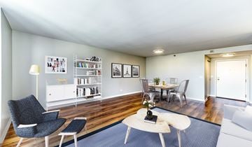 Evanston apartment for rent - A living room with a grey chair and a white sofa.