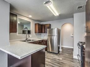Henderson apartment for rent - A kitchen with a stainless steel refrigerator and a white countertop.