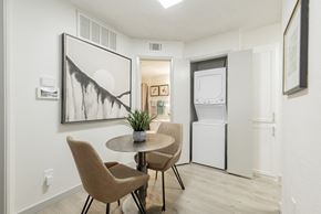Dallas apartment for rent - A dining room with a table and chairs and a framed artwork on the wall.
