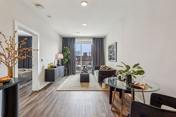 Nashville apartment for rent - A modern living room with a glass table and black chairs.