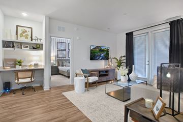 Lawrenceville apartment for rent - A living room with a couch, coffee table, and a painting on the wall.