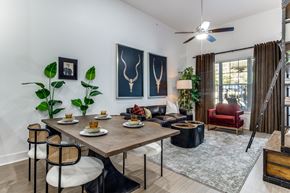 Dallas apartment for rent - A dining room with a table set for two and a red chair.