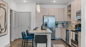 West Melbourne apartment for rent - A kitchen with a table and chairs in the middle of the room.