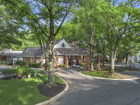 Atlanta apartment for rent - A tree in front of a building with a car parked in front of it.