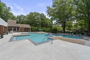 Atlanta apartment for rent - A swimming pool surrounded by trees and a building.