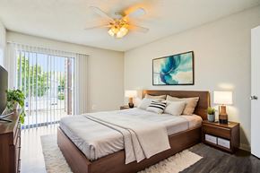 Austin apartment for rent - A bedroom with a large bed and a ceiling fan.