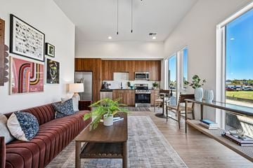 Arvada apartment for rent - A modern living room with a red couch and a coffee table.