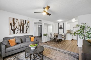 Phoenix apartment for rent - A living room with a grey couch and a brown bowl on the coffee table.