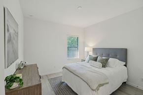 South Naples townhouse for rent - A bedroom with a large bed and a painting on the wall.