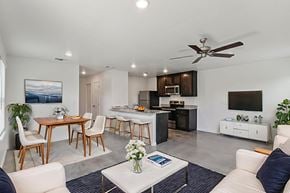 Harker Heights townhouse for rent - A modern living room with a dining area and kitchen in the background.