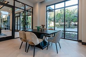 Dallas apartment for rent - A black dining table with four chairs in front of a glass wall.