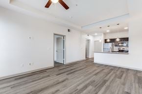 Lewisville apartment for rent - A spacious room with a ceiling fan and wooden flooring.