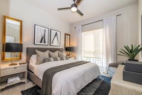 Dallas apartment for rent - a bedroom with a large bed and a window