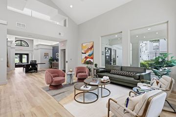 Irving apartment for rent - A living room with a grey couch, a coffee table, and a large painting on the wall.