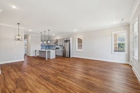 Spring Hill apartment for rent - A kitchen with a dining table and chairs is visible through a glass door.