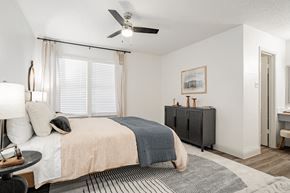 Arlington apartment for rent - a bedroom with a bed and a ceiling fan