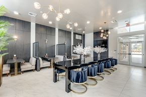 Dallas apartment for rent - A modern dining room with a long table set for a meal.
