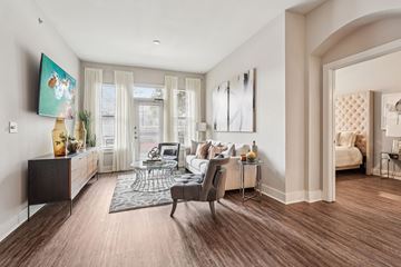 Atlanta apartment for rent - A living room with a grey sofa and a painting on the wall.