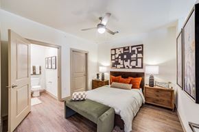 Georgetown apartment for rent - A bedroom with a bed, nightstand, and a painting on the wall.