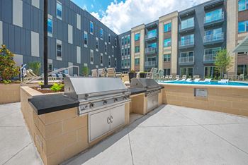 Outdoor entertaining courtyard with games, grills, and paseo