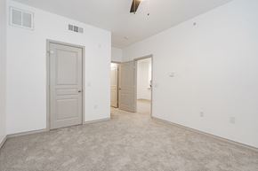 Garland apartment for rent - a bedroom with white walls and carpet and a door to a closet