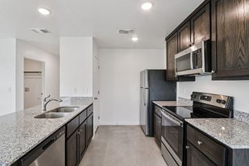 Harker Heights townhouse for rent - A kitchen with black cabinets and stainless steel appliances.