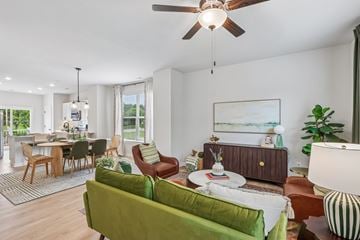 Charlotte townhouse for rent - A living room with a green couch and a ceiling fan.