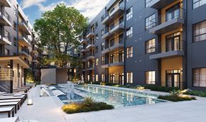 Austin apartment for rent - A modern apartment complex with a pool in the courtyard.