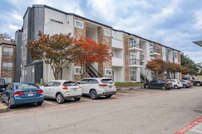 Dallas apartment for rent - an apartment building with cars parked in front of it