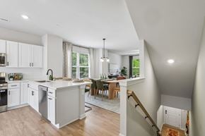 Charlotte townhouse for rent - A modern kitchen with white cabinets and a large island.