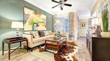 Houston apartment for rent - a living room filled with furniture and a ceiling fan