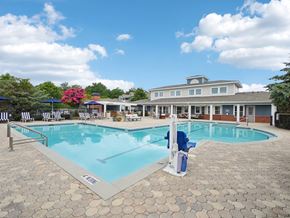 Apex apartment for rent - Resort-style swimming pool and outdoor lounge area at Village at Broadstone Station apartments in Apex, NC