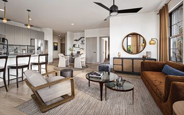 Atlanta apartment for rent - A modern living room with a brown chair and a brown couch.