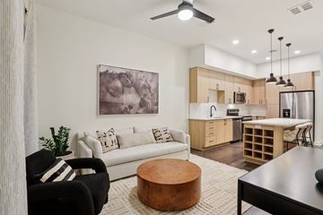 Nashville apartment for rent - A modern living room with a black chair and a white couch.