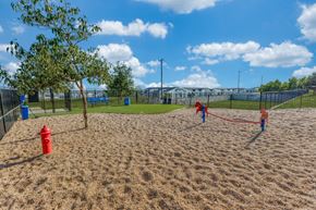 Georgetown apartment for rent - two children playing on a sand volleyball court at a park