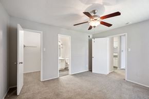 Houston apartment for rent - an empty room with mirrored doors and a ceiling fan