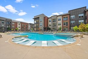 Brighton apartment for rent - an outdoor pool with an apartment building in the background
