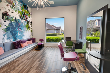 Pearland apartment for rent - A living room with a grey sofa and a large window.